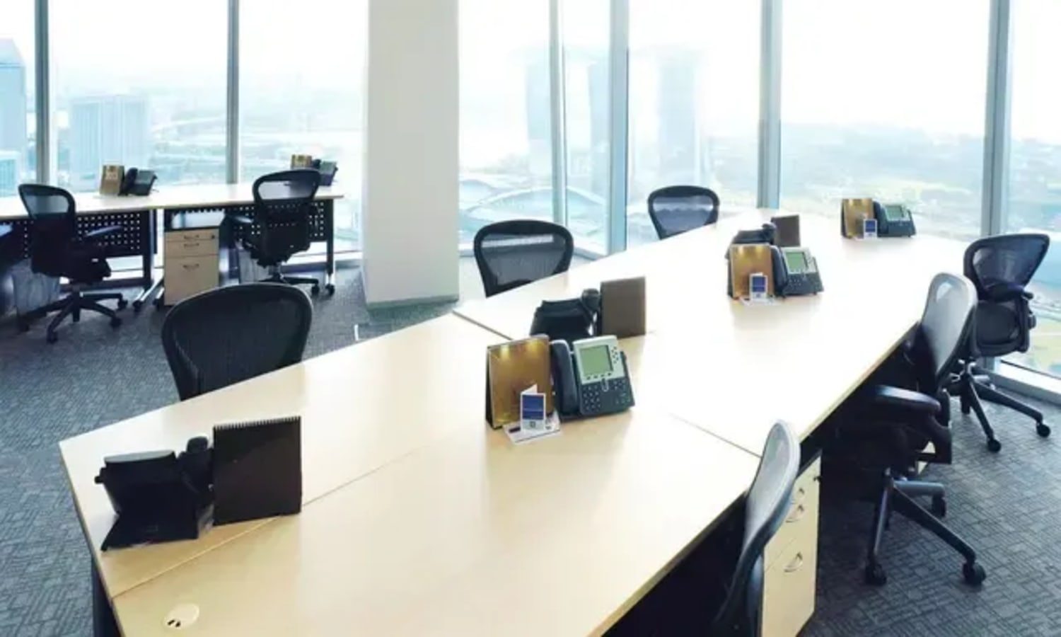 Bright coworking space with expansive city views and ergonomic seating in Collyer Quay.