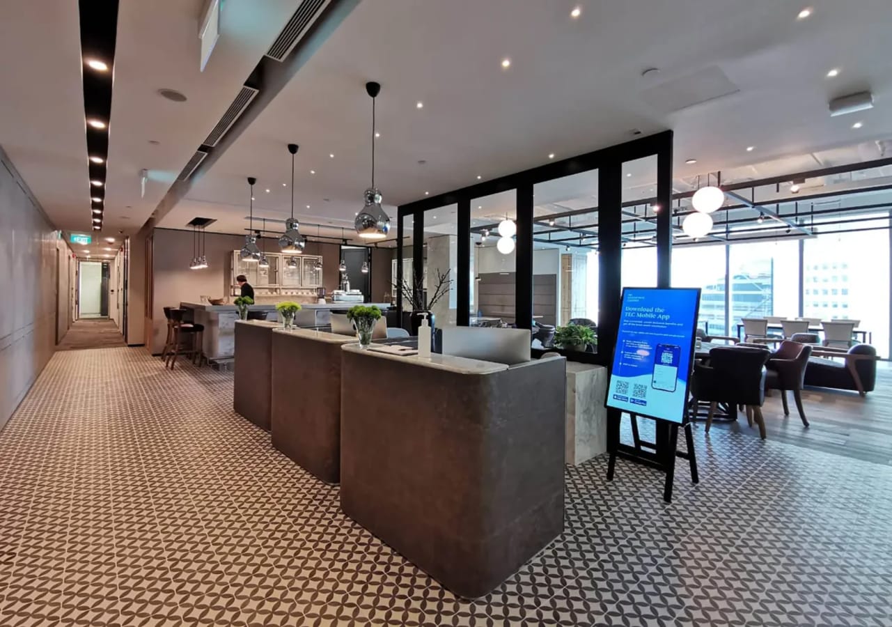 Elegant coworking space with modern design, natural light, and versatile seating in Collyer Quay.