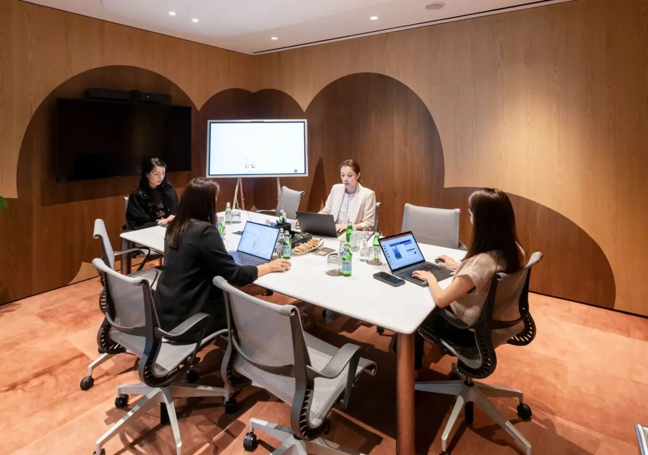 Modern coworking space with sleek furniture, ideal for collaboration and meetings.