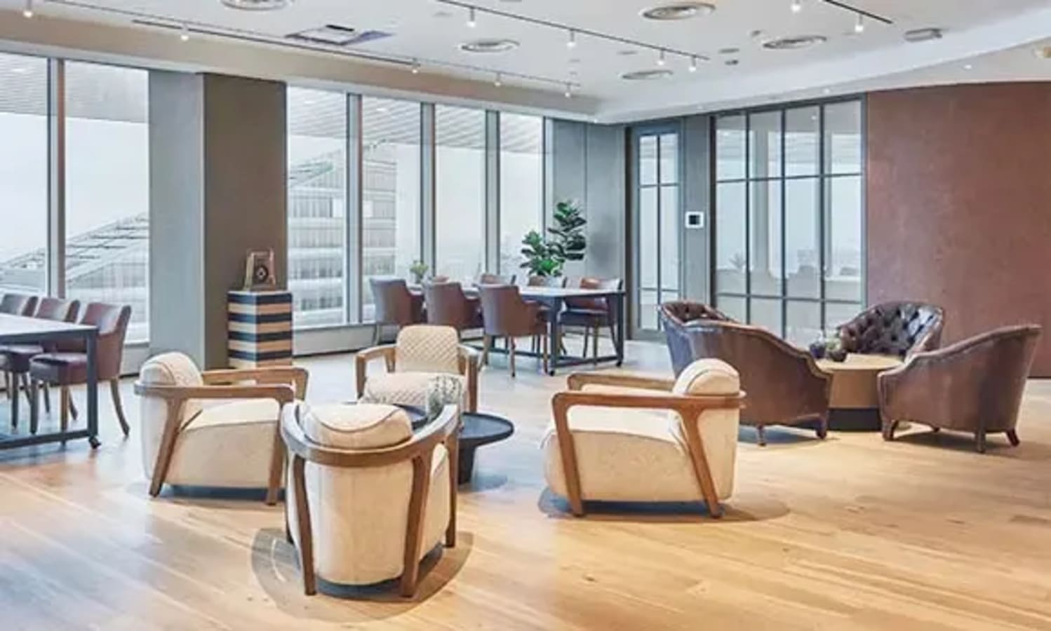 Spacious coworking area with modern furnishings and abundant natural light, ideal for collaboration.