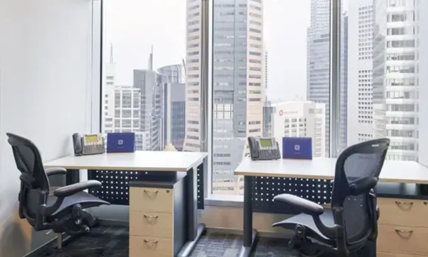 Modern coworking space with stunning city views, ergonomic chairs, and ample desk space.
