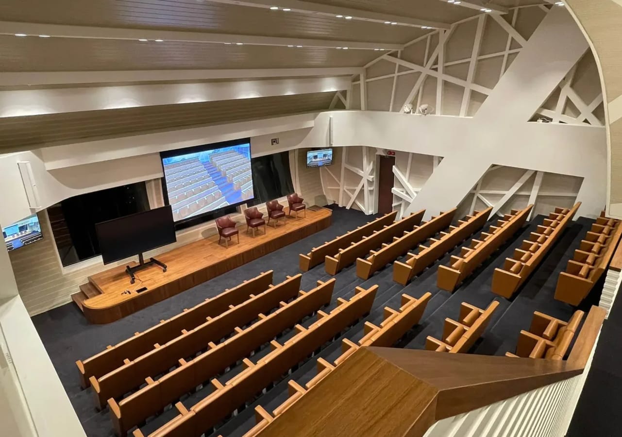 Spacious auditorium with modern seating, large screen, and sleek design in Singapore's Marina Boulevard.