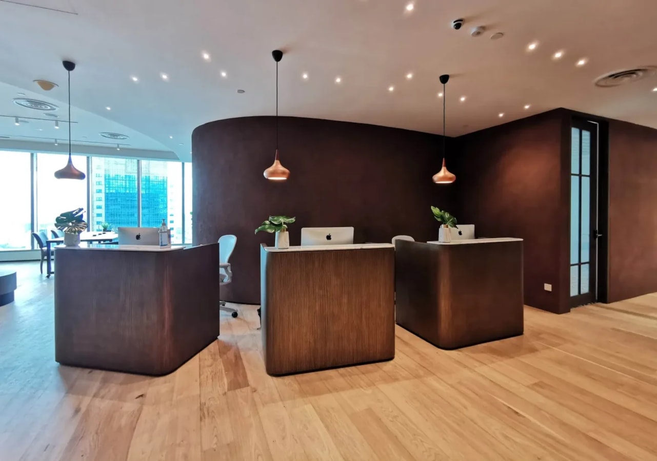 Sleek reception area with modern design and warm lighting in a Marina Boulevard coworking space.