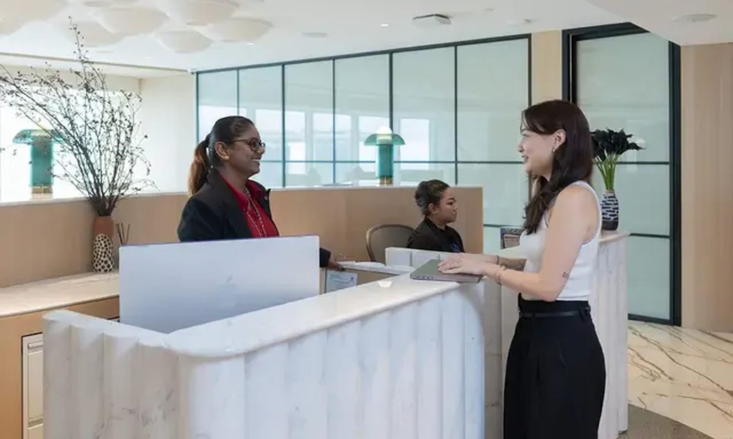 Welcoming reception area in Raffles Place coworking space, featuring modern design and friendly staff.