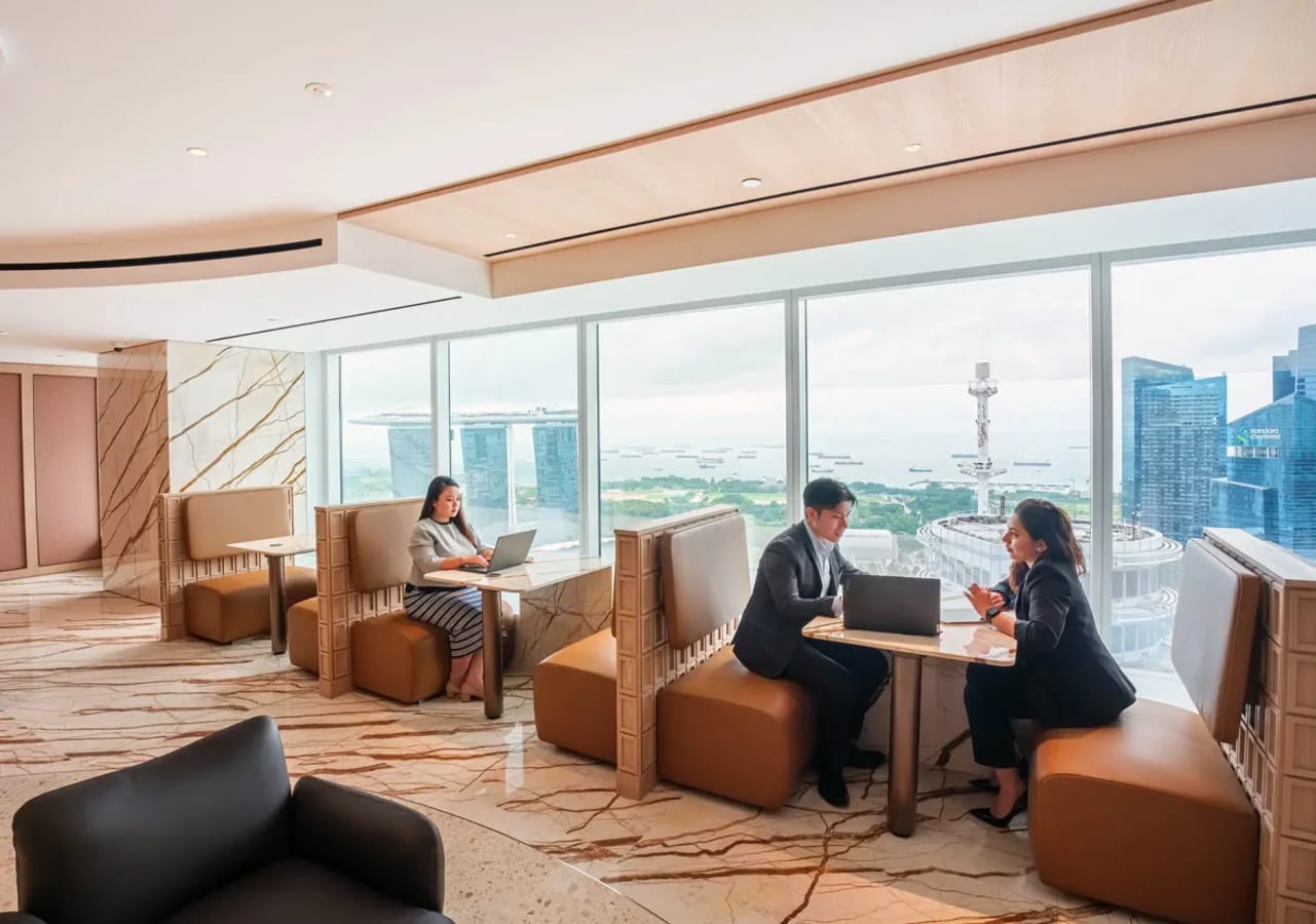 Bright coworking space with modern booths and stunning views at Raffles Place.