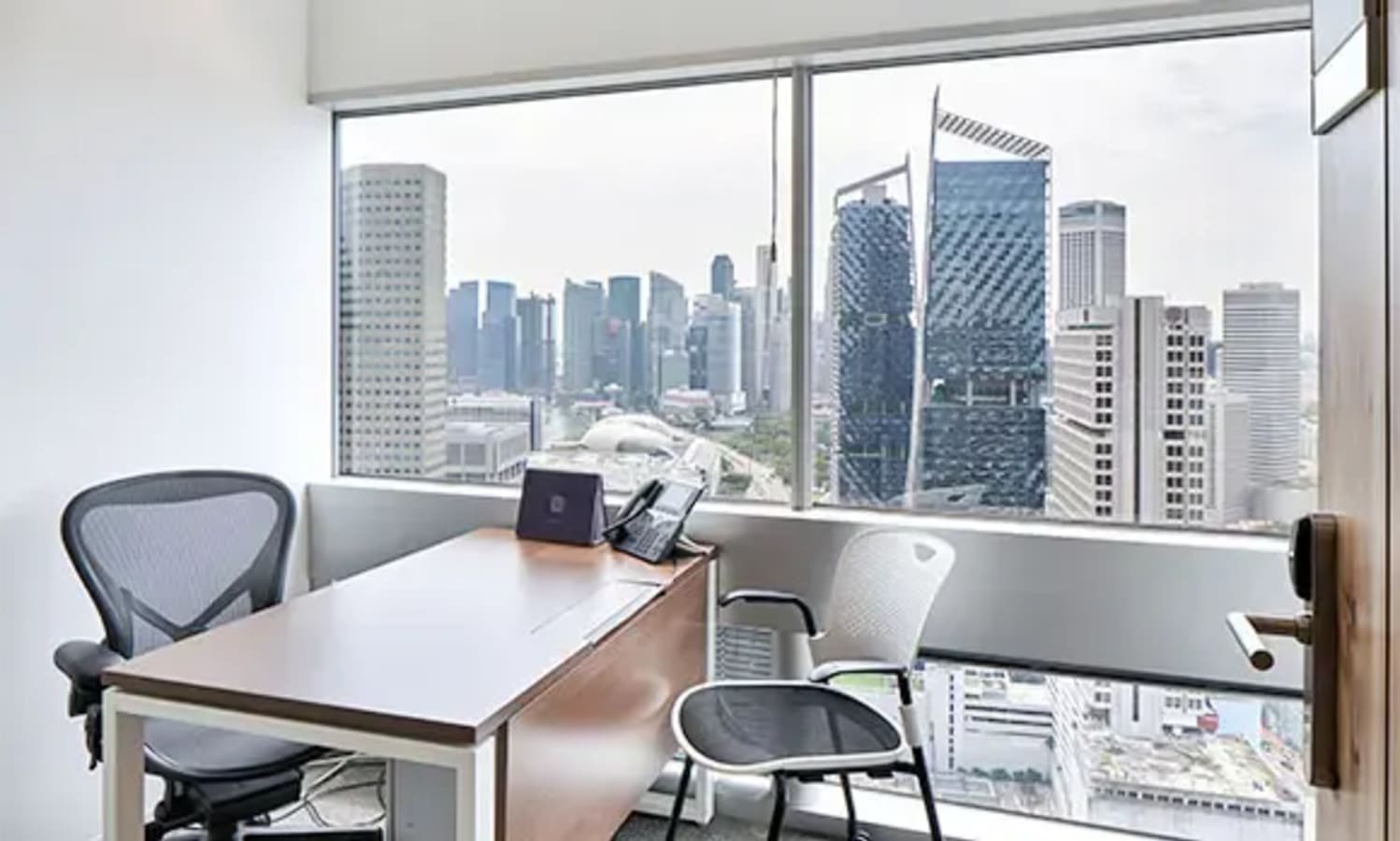 Stylish private office with cityscape views, ergonomic seating, and abundant natural light.