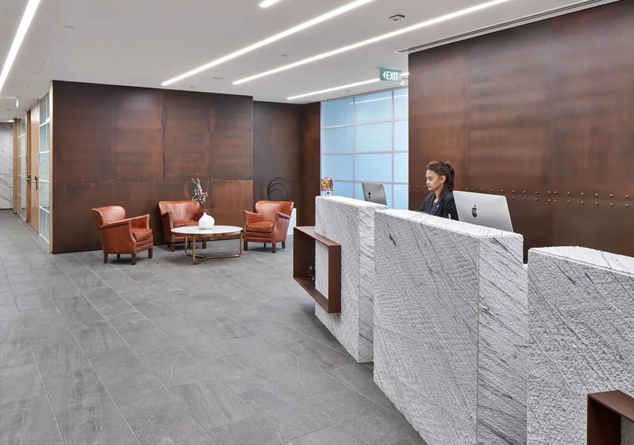 Stylish coworking reception with cozy seating, modern lighting, and a welcoming atmosphere.