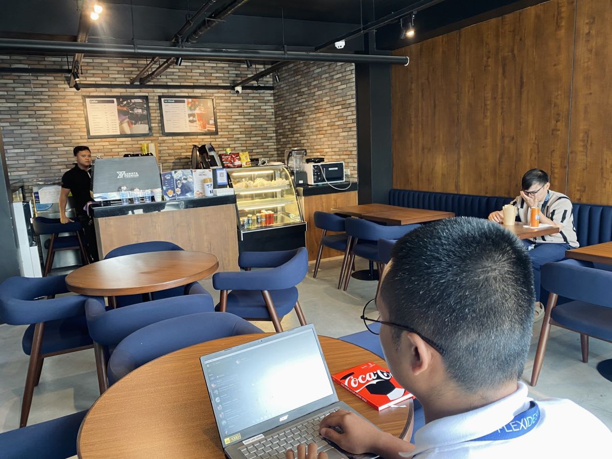 Cozy coworking café with modern seating, ideal for work and meetings, located in Angel St.