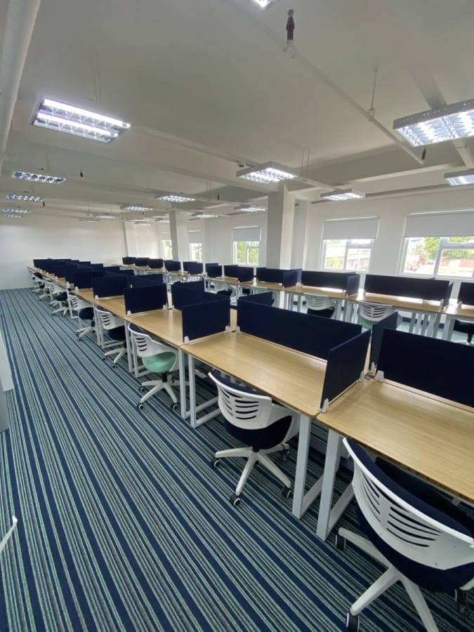 Modern coworking space with ample natural light and sleek, ergonomic workstations in Angel St.