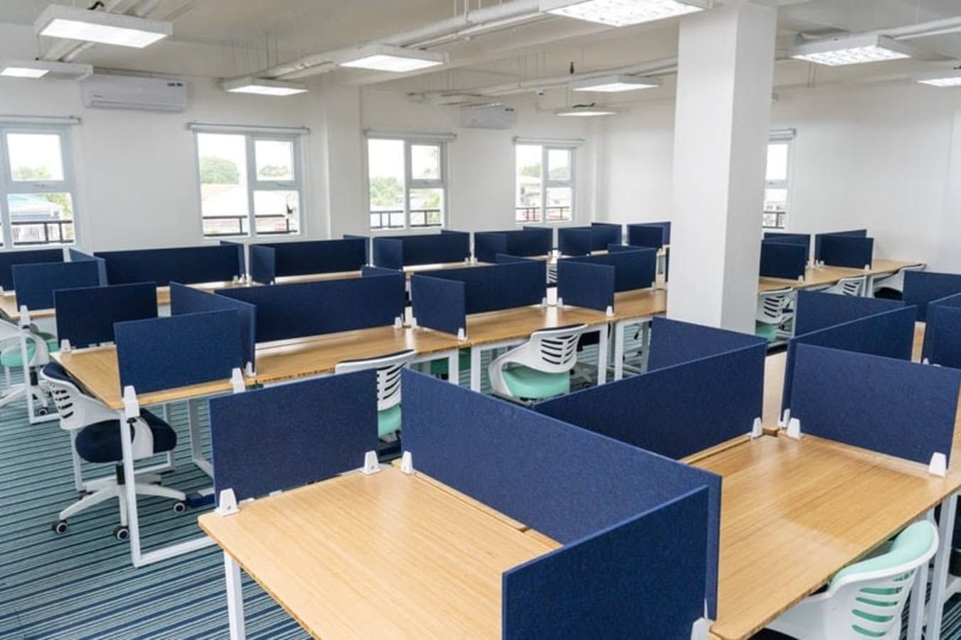 Bright coworking space with modern workstations and ample natural light. Perfect for collaboration.