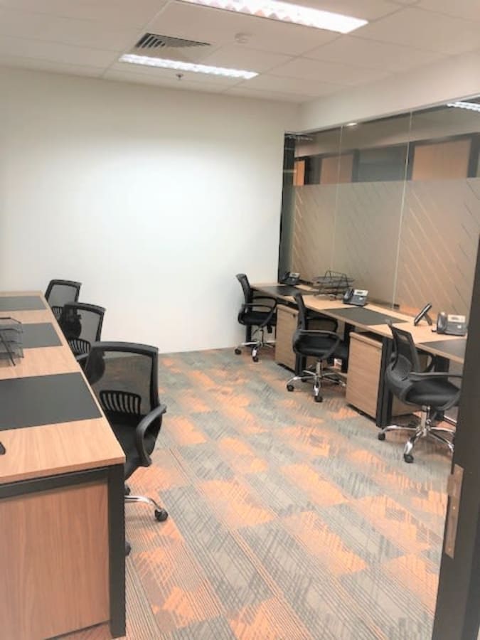 Modern coworking space with ergonomic chairs and sleek workstations in Singapore.