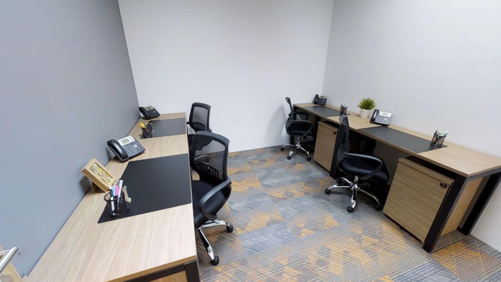 Modern coworking space with ergonomic chairs, ample desk space, and neutral decor.