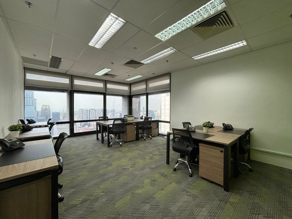 Bright coworking space with city views, modern desks, and ample natural light. Perfect for teams.