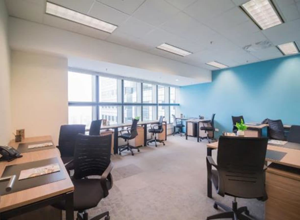 Bright, modern coworking space with flexible seating and large windows in Temasek Boulevard.