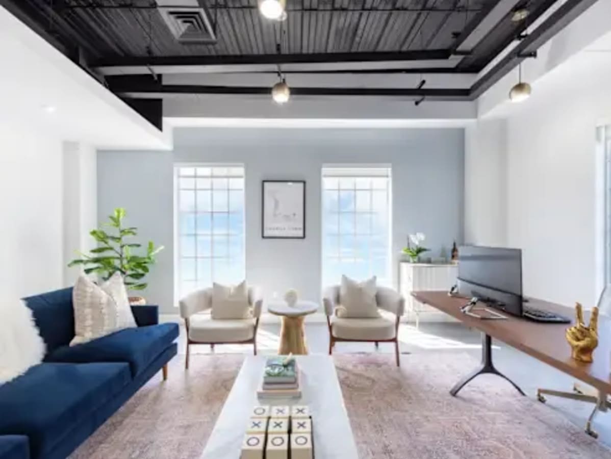 Bright coworking space with modern decor, natural light, and comfortable seating. Perfect for productivity.