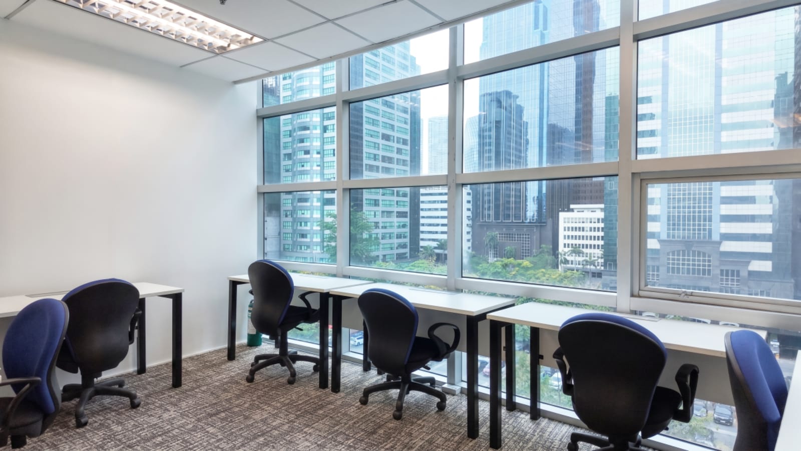 Bright coworking space with city views, ergonomic chairs, and natural light on Meralco Avenue.