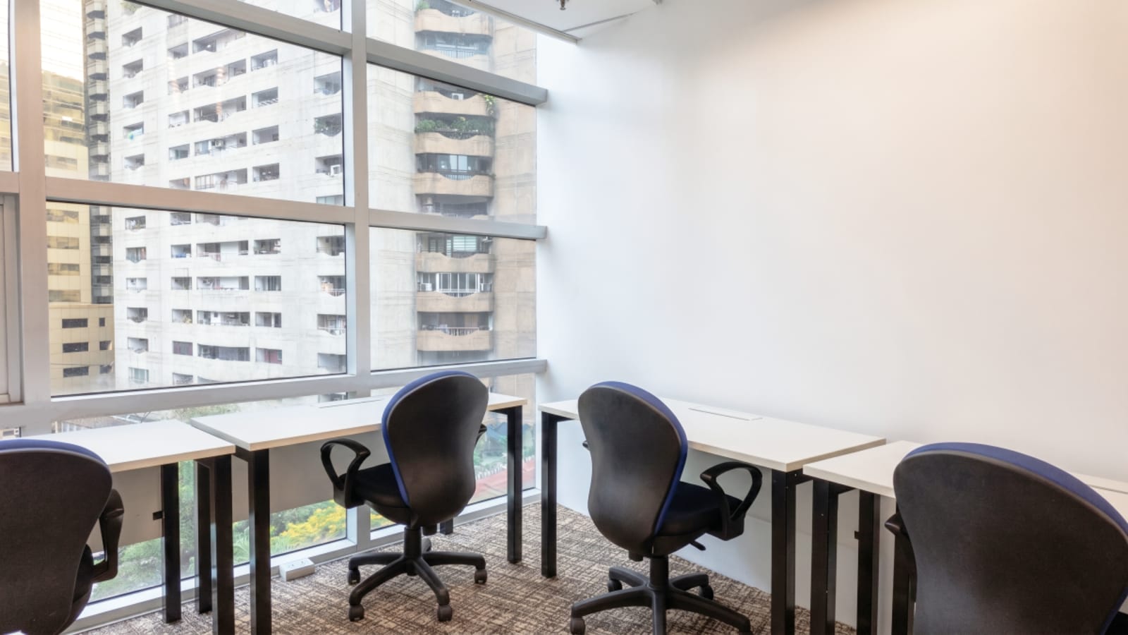 Bright coworking space with large windows, ergonomic chairs, and a modern layout on Meralco Avenue.
