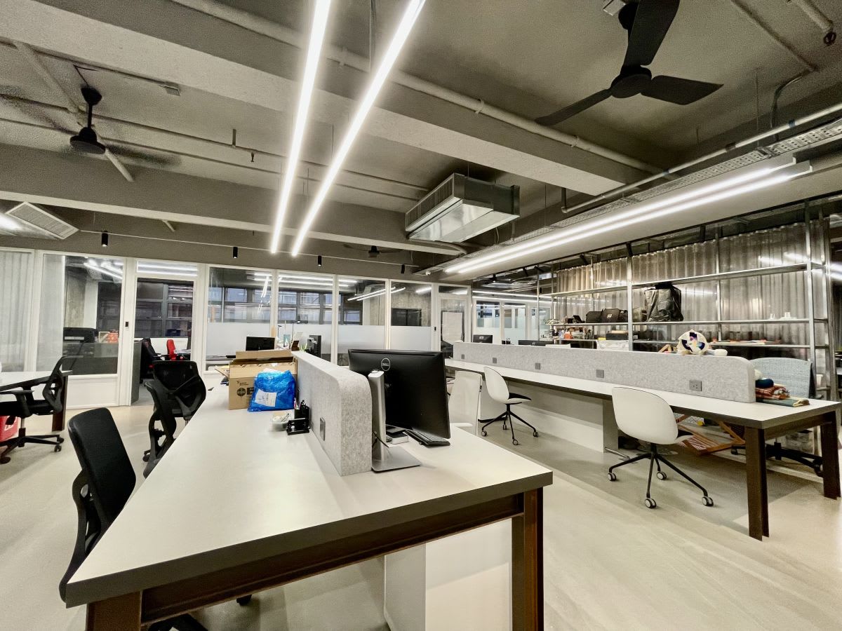Modern coworking space with open layout, sleek workstations, and ample lighting in New Territories.
