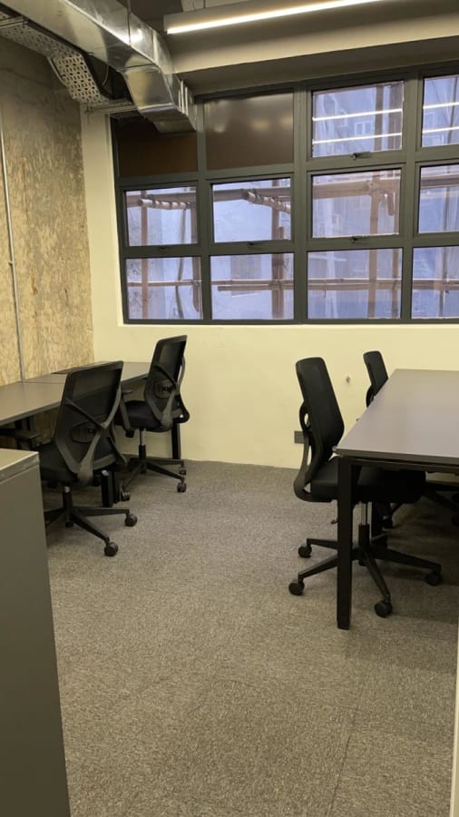 Modern coworking space with natural light and ergonomic chairs in Chai Wan Kok Street.
