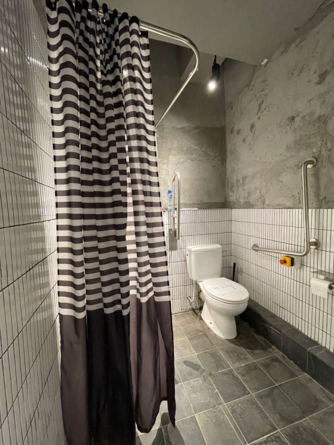 Accessible restroom featuring modern fixtures and stylish design in Chai Wan Kok's coworking space.