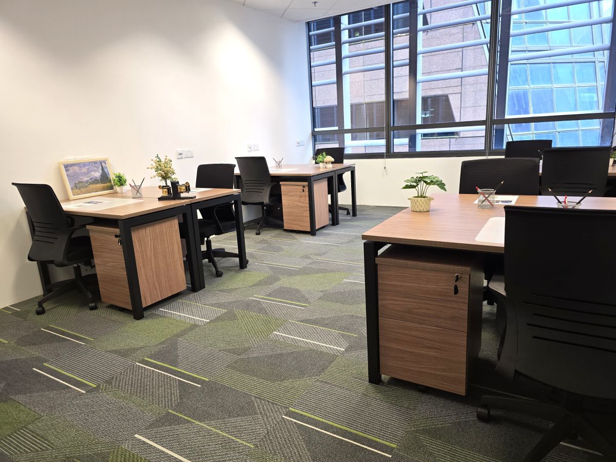 Modern coworking space with sleek desks, ergonomic chairs, and large windows for natural light.
