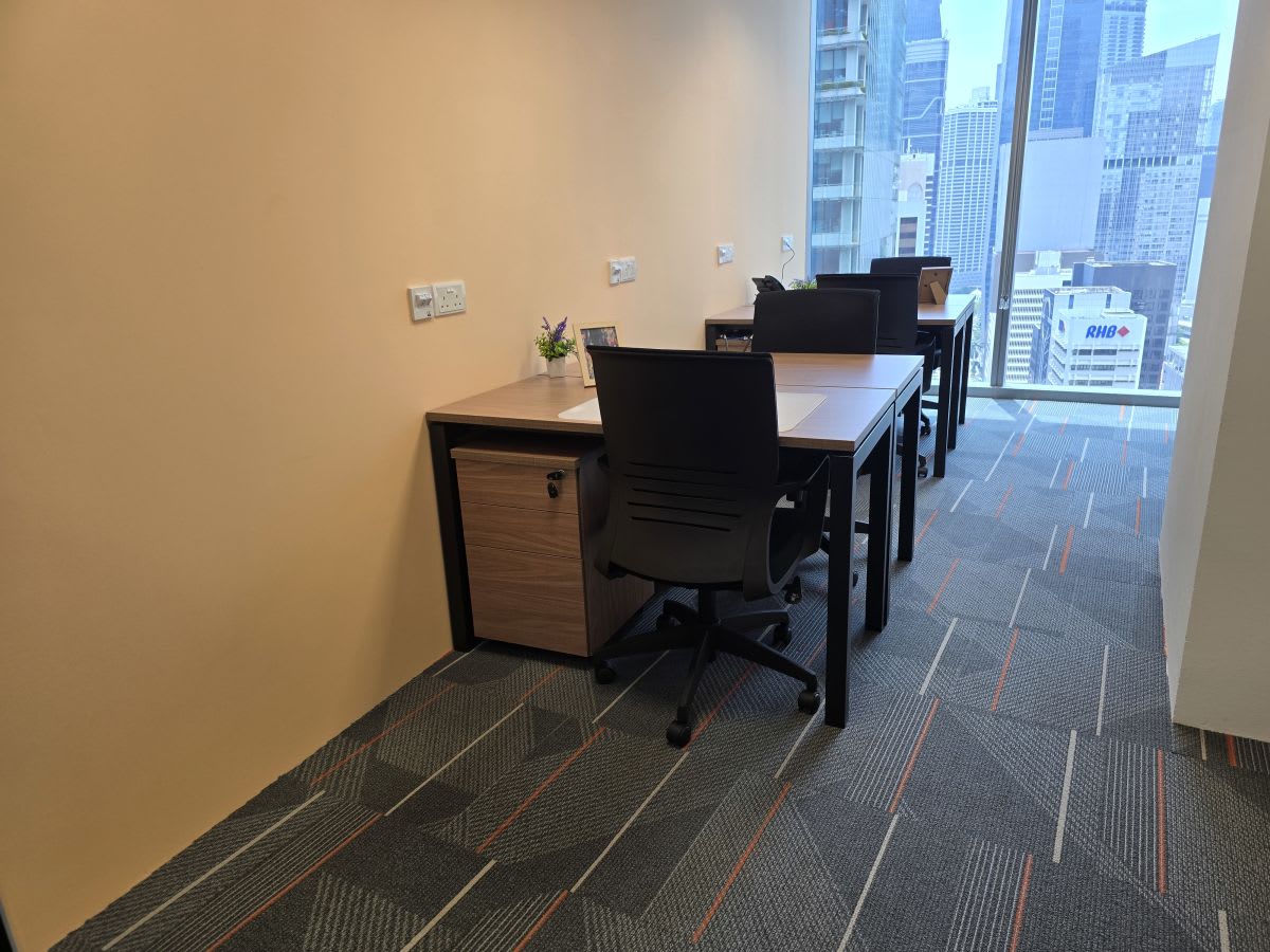 Modern coworking space with city views, ergonomic chairs, and natural lighting.