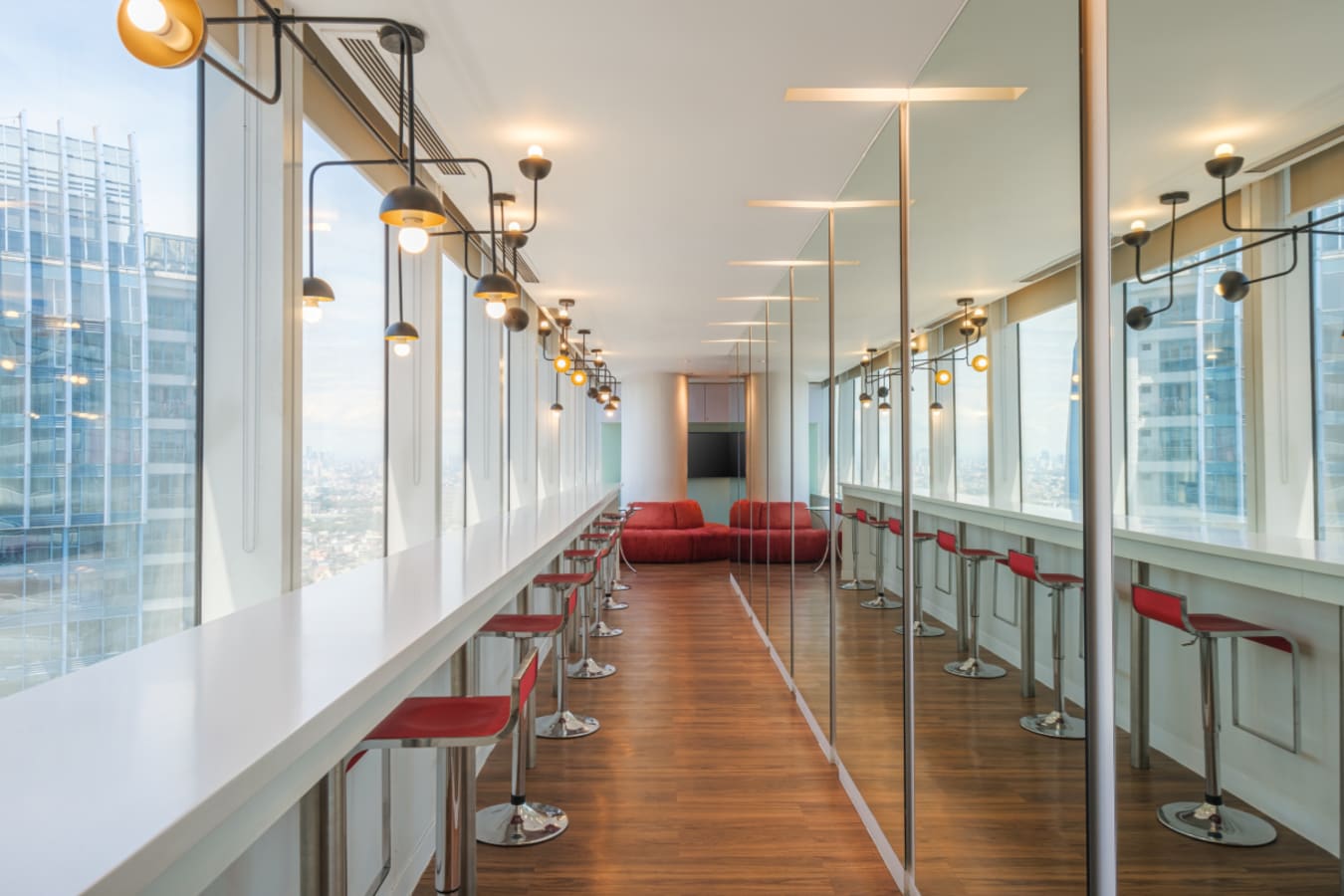 Bright, modern coworking space with high stools and city views on Ayala Avenue. Ideal for productivity.