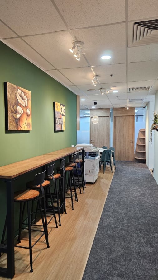 Stylish coworking space with bar seating, modern decor, and natural lighting on Cecil Street.