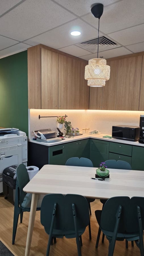 Cozy kitchen area with ample seating, modern appliances, and warm lighting. Perfect for breaks.