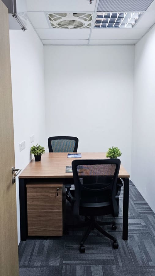 Compact and private workspace with modern furniture and natural lighting. Ideal for solo work.