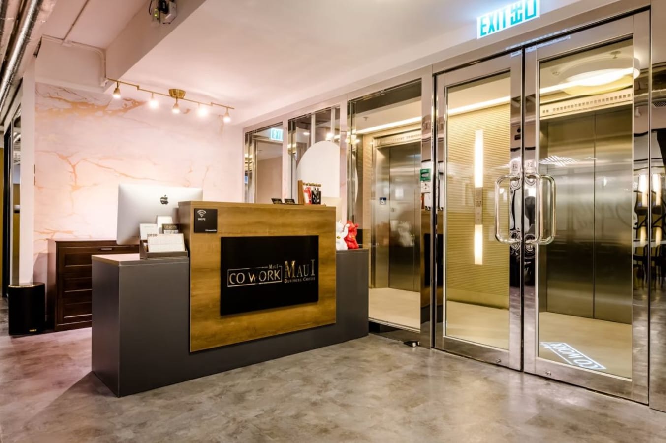 Sleek reception area with modern design and glass entry, perfect for a professional coworking space.