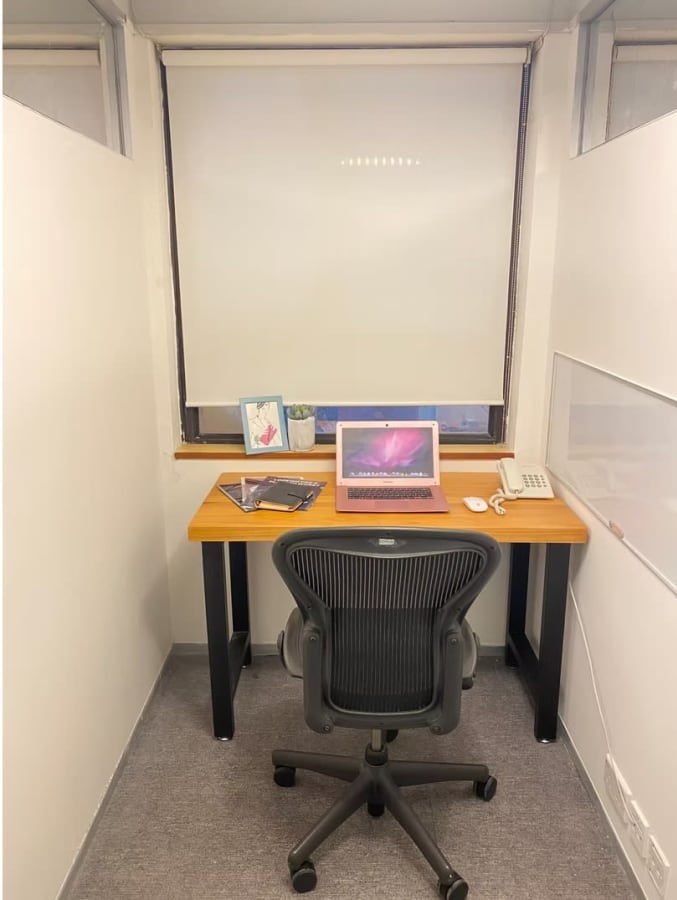 Cozy workspace with natural light, ergonomic chair, and essential desk setup on Hysan Avenue.