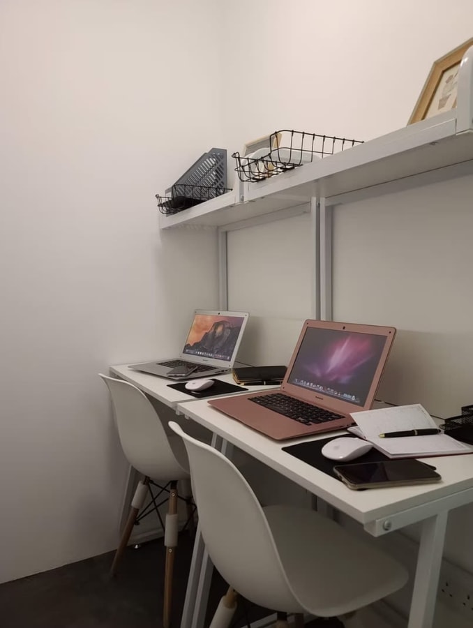 Cozy coworking corner with sleek desks and modern chairs, perfect for focused work in Hysan Avenue.