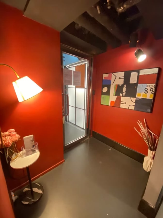 Vibrant entry with modern art and ambient lighting in a flexible coworking space.