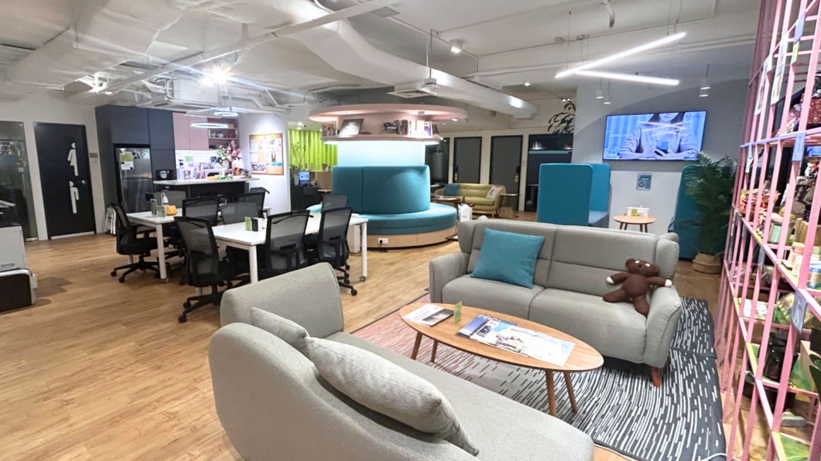 Modern coworking space with versatile seating, vibrant decor, and collaborative areas.