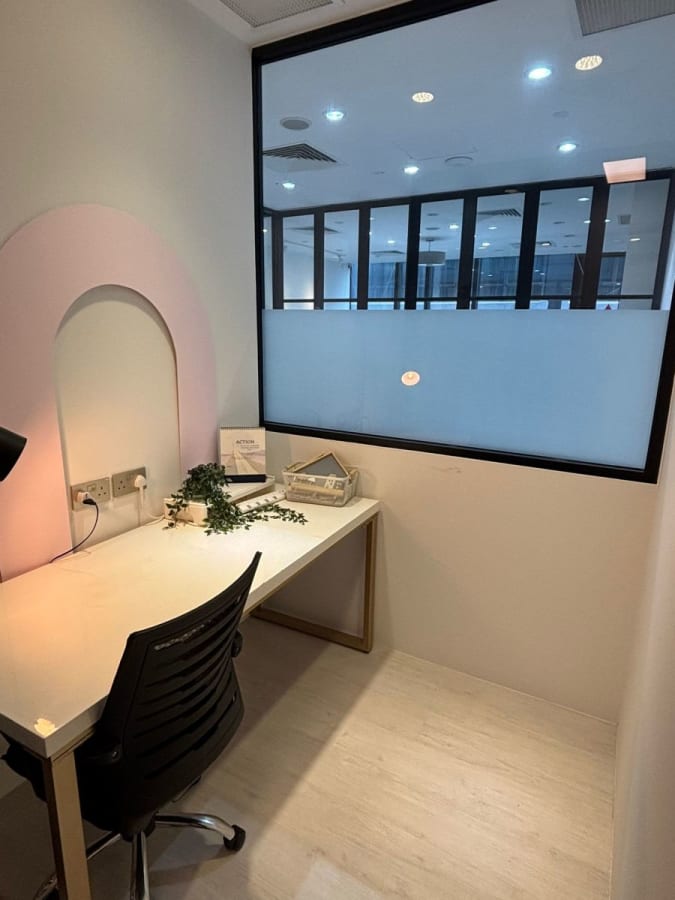 Sleek private workspace with ample natural light and modern furnishings. Ideal for focus and productivity.