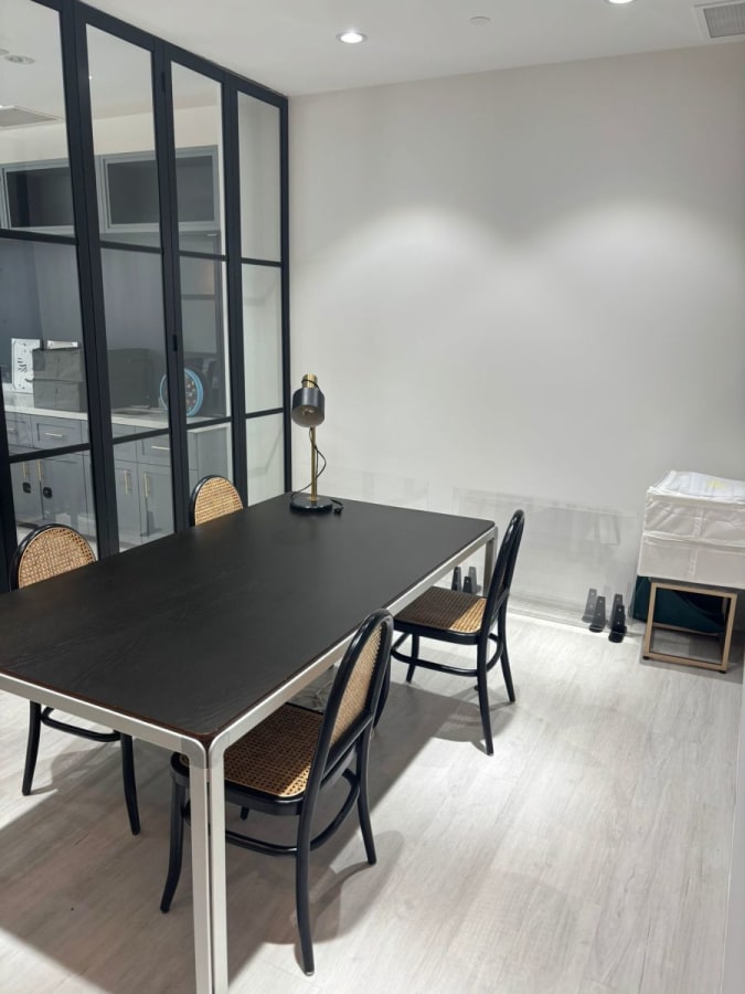 Contemporary coworking space with sleek table, natural lighting, and quiet ambiance.