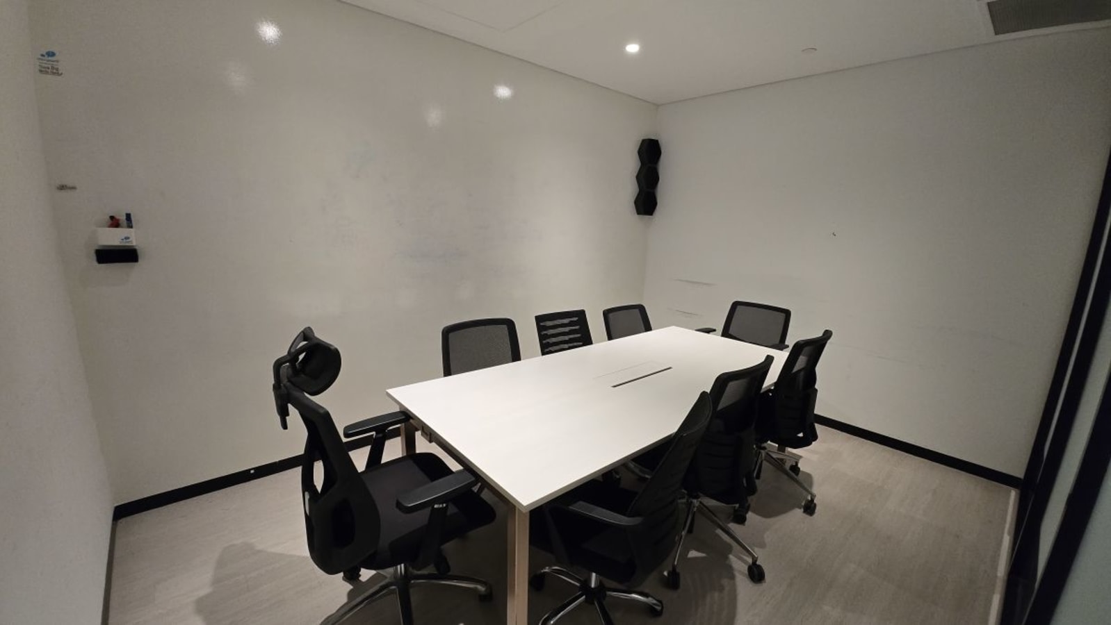 Modern meeting room with ergonomic chairs and a sleek table, ideal for collaborative work.