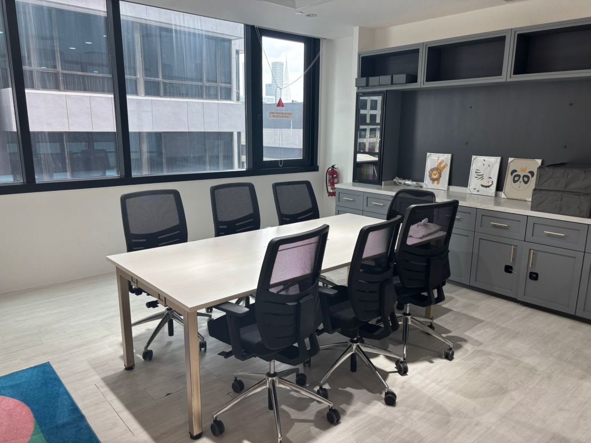 Bright, modern meeting room with ample seating and natural light in Singapore's coworking hub.