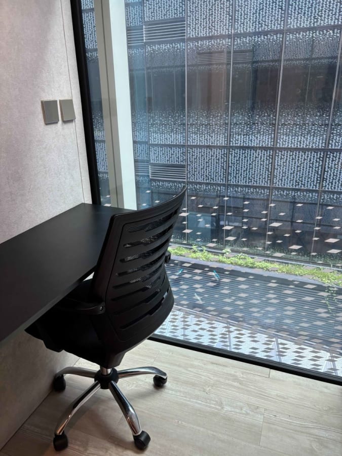 Sleek workspace with city views. Modern desk and ergonomic chair included. Perfect for focus.