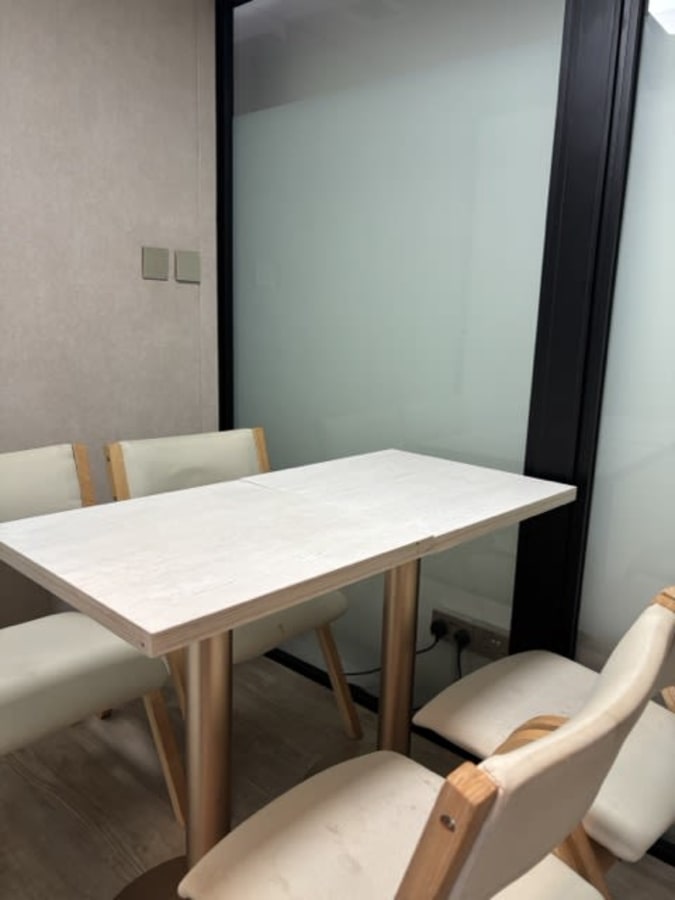 Sleek private meeting room with modern decor and comfortable seating in a Singapore coworking space.
