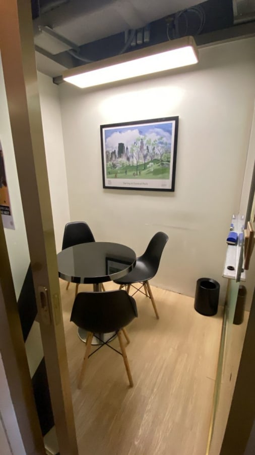 Compact meeting room with stylish seating and modern decor, ideal for focused discussions.