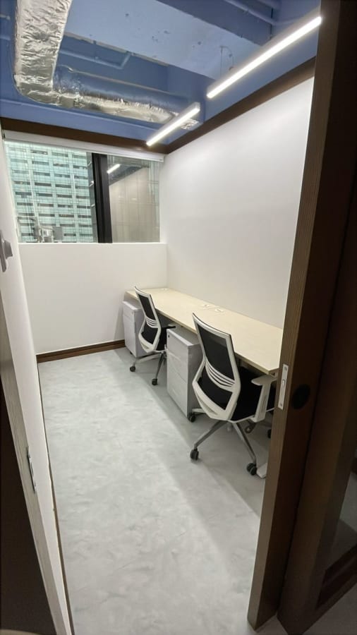 Modern coworking space with natural light, sleek desks, and ergonomic chairs on Wellington Street.