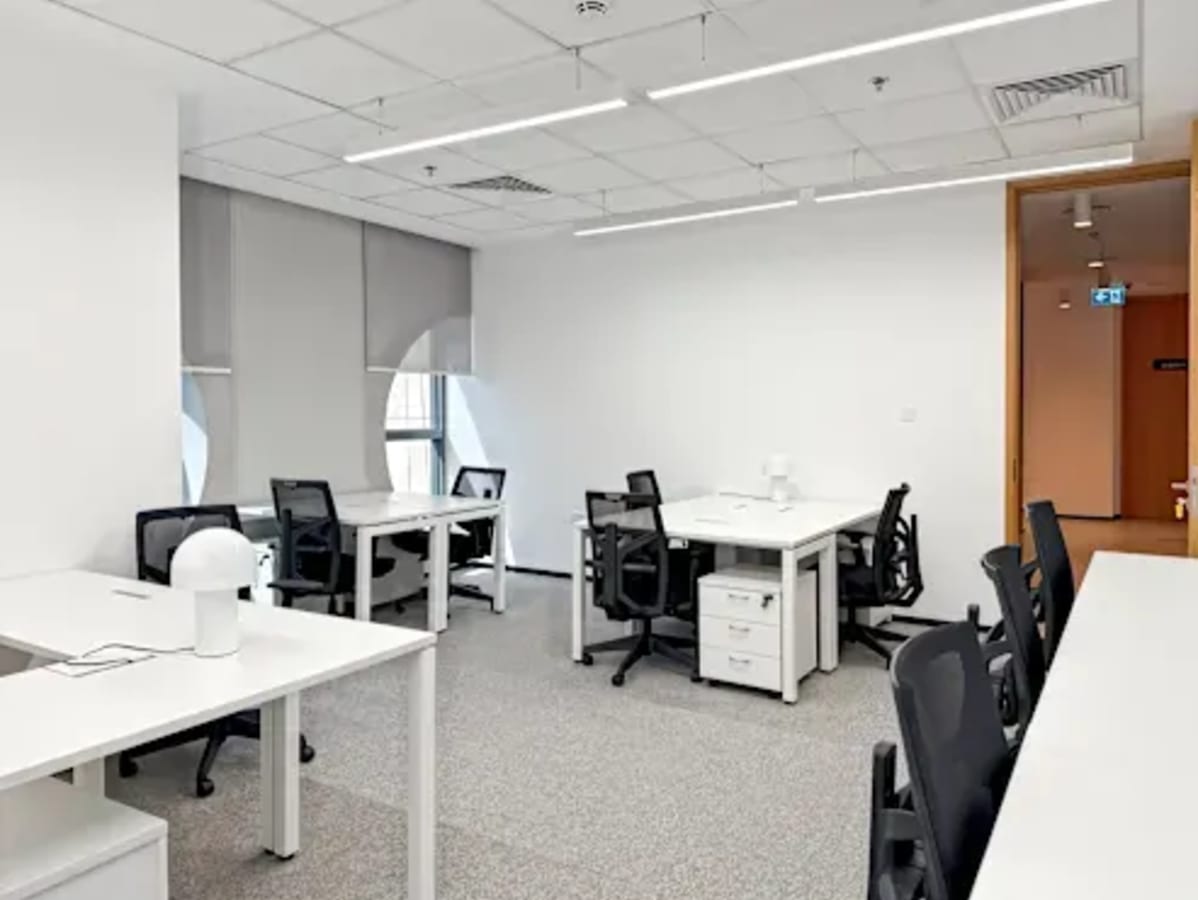 Modern coworking space with sleek desks, comfy chairs, and abundant natural light in Port Saeed.