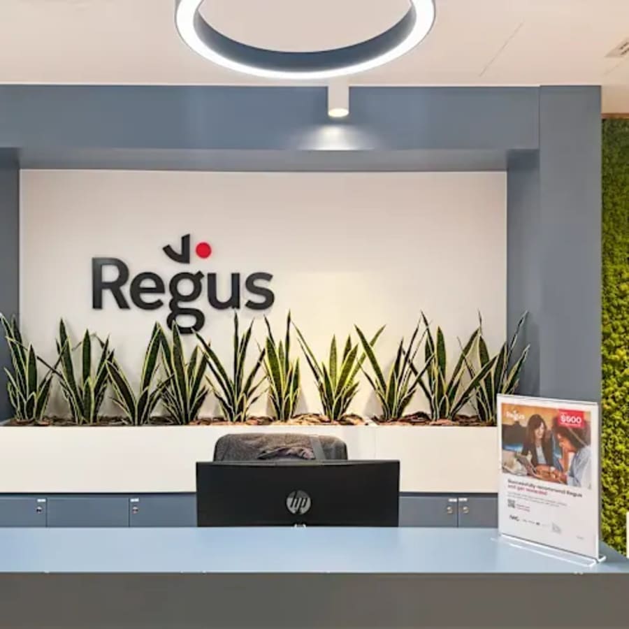 Modern reception area with greenery in a vibrant coworking space, Port Saeed Deira, Dubai.