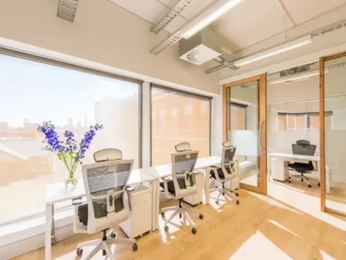 Bright coworking space with modern desks, ergonomic chairs, and natural light in Trade Center Second, Dubai.