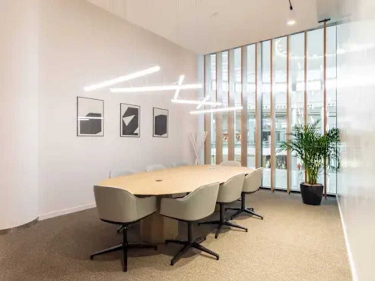 Modern meeting room with sleek lighting and natural light in Downtown Dubai coworking space.