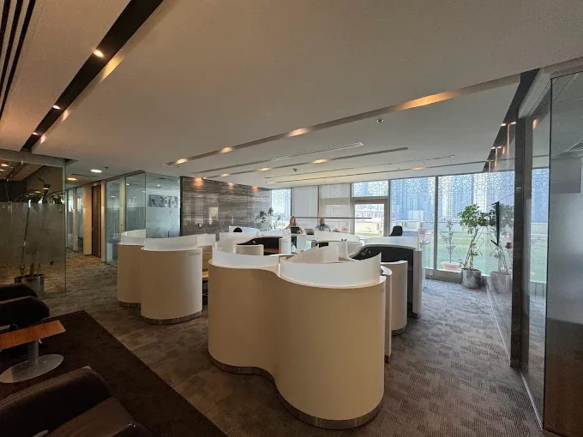 Modern coworking space with sleek workstations, natural light, and city views in Downtown Dubai.