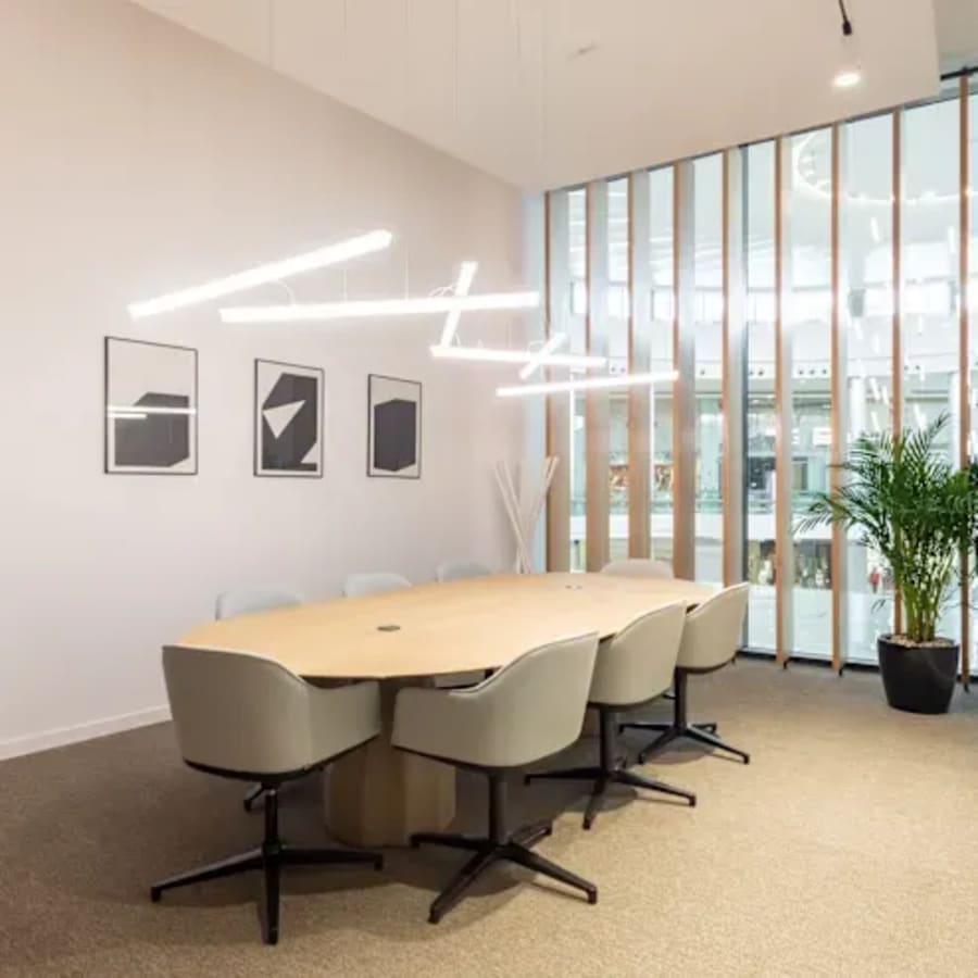 Sleek coworking space with modern lighting, elegant furniture, and natural light in Burj Khalifa District.