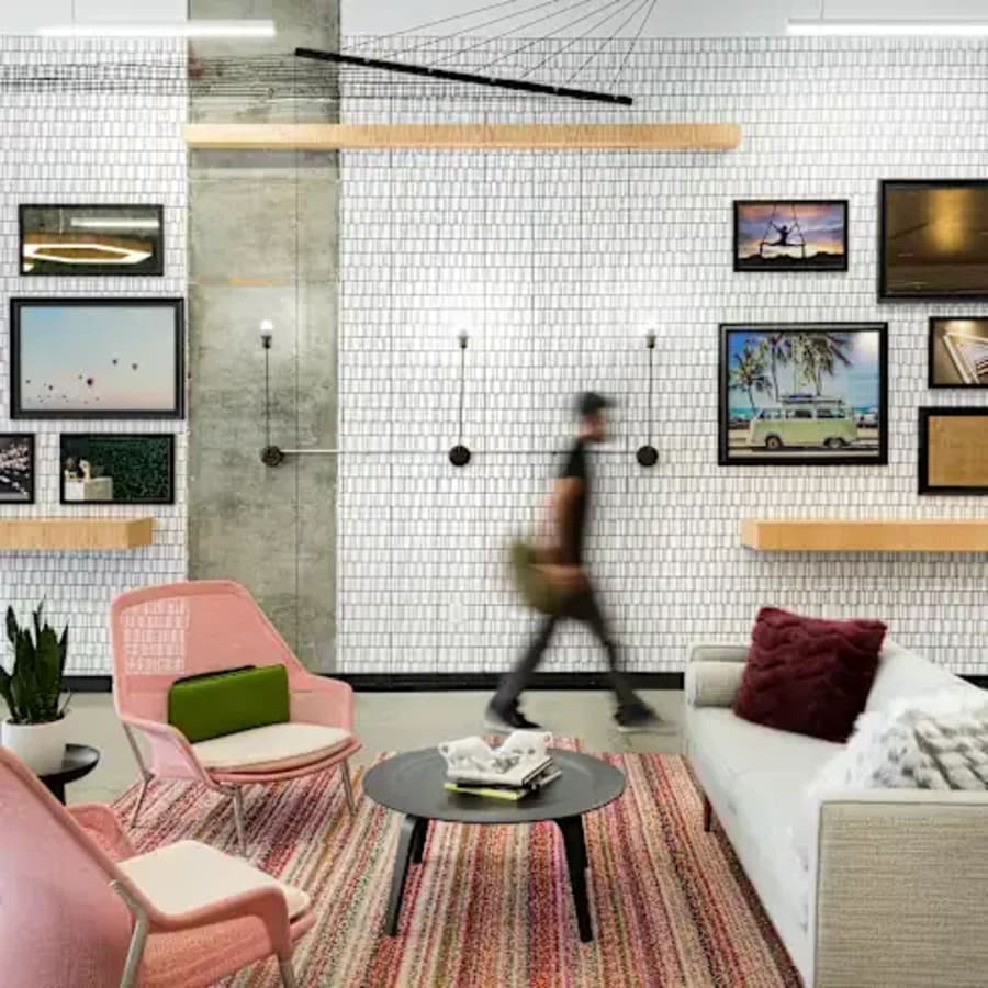 Stylish lounge with modern decor, vibrant seating, and creative artwork in Dubai Media City.